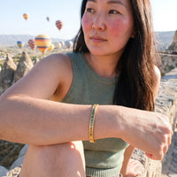 Thumbnail for Be Gorgeous, Be Yourself bracelet in gold worn on a getaway | SKU: bgby-g