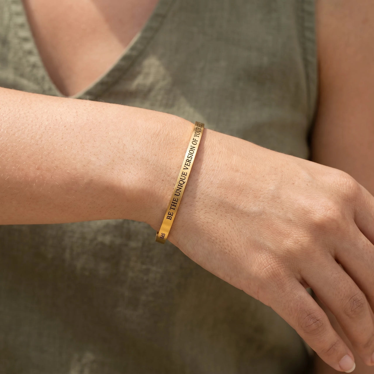Close-up of the Be The Unique Version Of Yourself bracelet in gold worn | SKU: btuvoy-g
