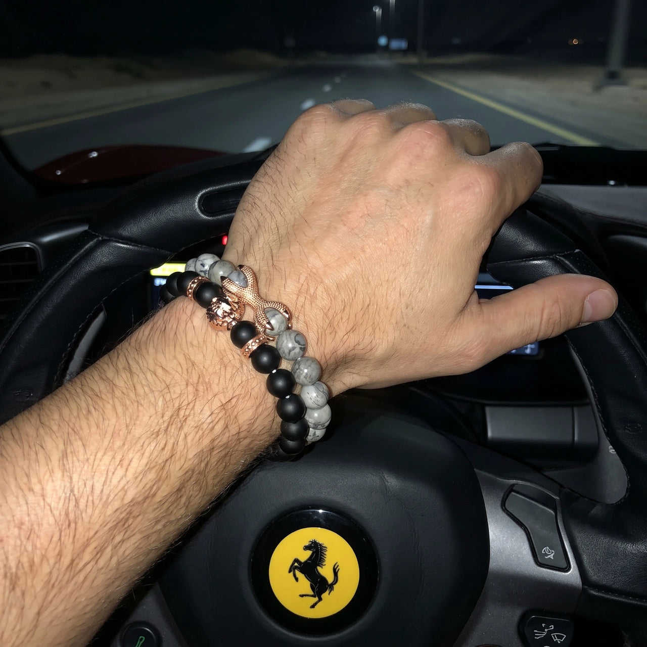 Rose Gold Lion with Black & Grey Stones Set – worn at the steering wheel of a luxury car | Brother & Sisters | SKU: 21369621-rose-gold-XS-14-15, 21369621-rose-gold-S-16-17, 21369621-rose-gold-M-18-19, 21369621-rose-gold-L-20-21, 21369621-rose-gold-XL-22-23