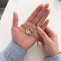 Thumbnail for Thumb warming the gold octagon bracelet plate: the hidden photo appears under the thumb while the rest stays black | SKU: TPH-OCTB-GOLD-18