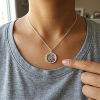 Thumbnail for Looking down at the silver round pendant next to her fingertip, real small size, twins' photo inside | SKU: TPH-RNDN-SILVER