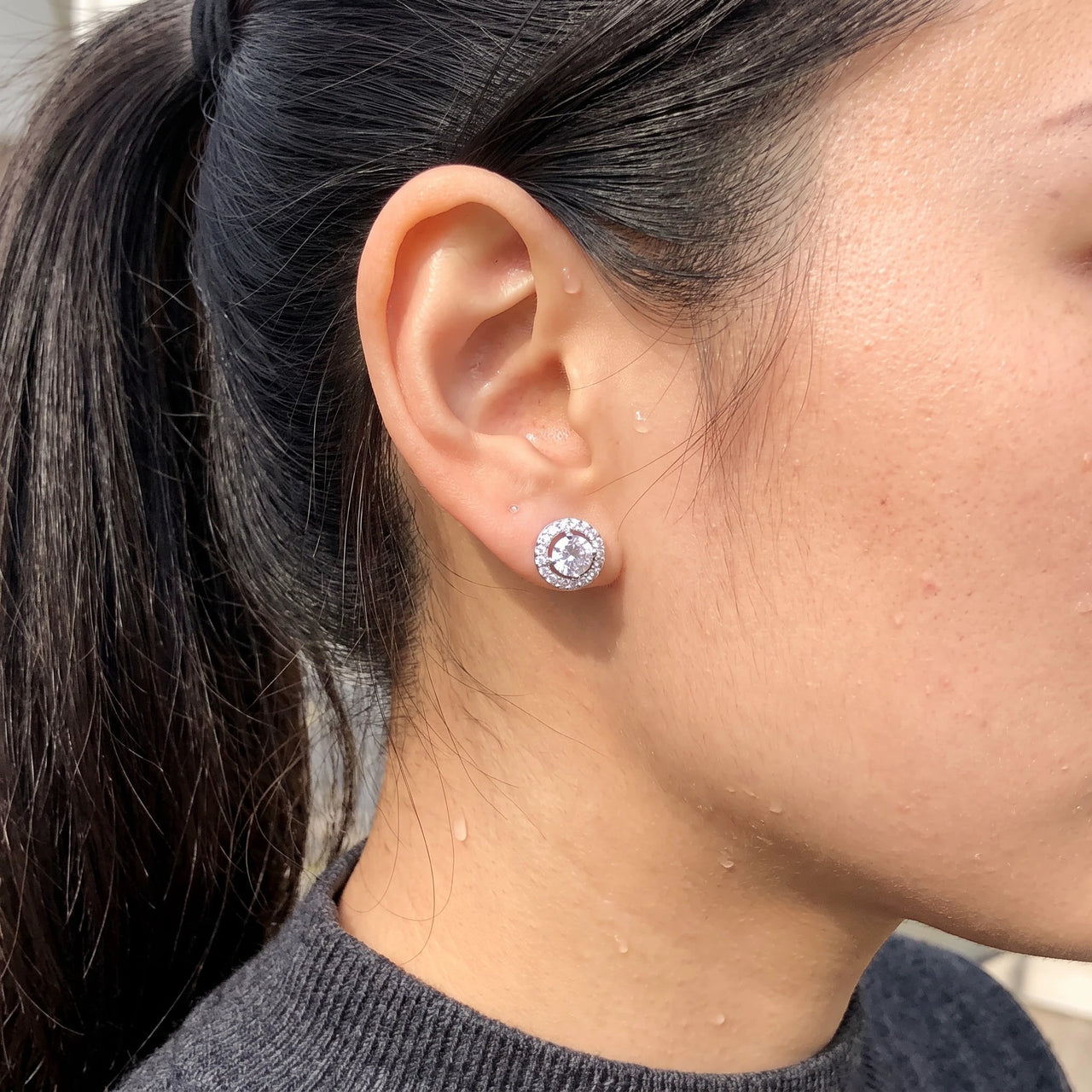 Close-up of the silver stud earrings worn on the skin | SKU: 19991927