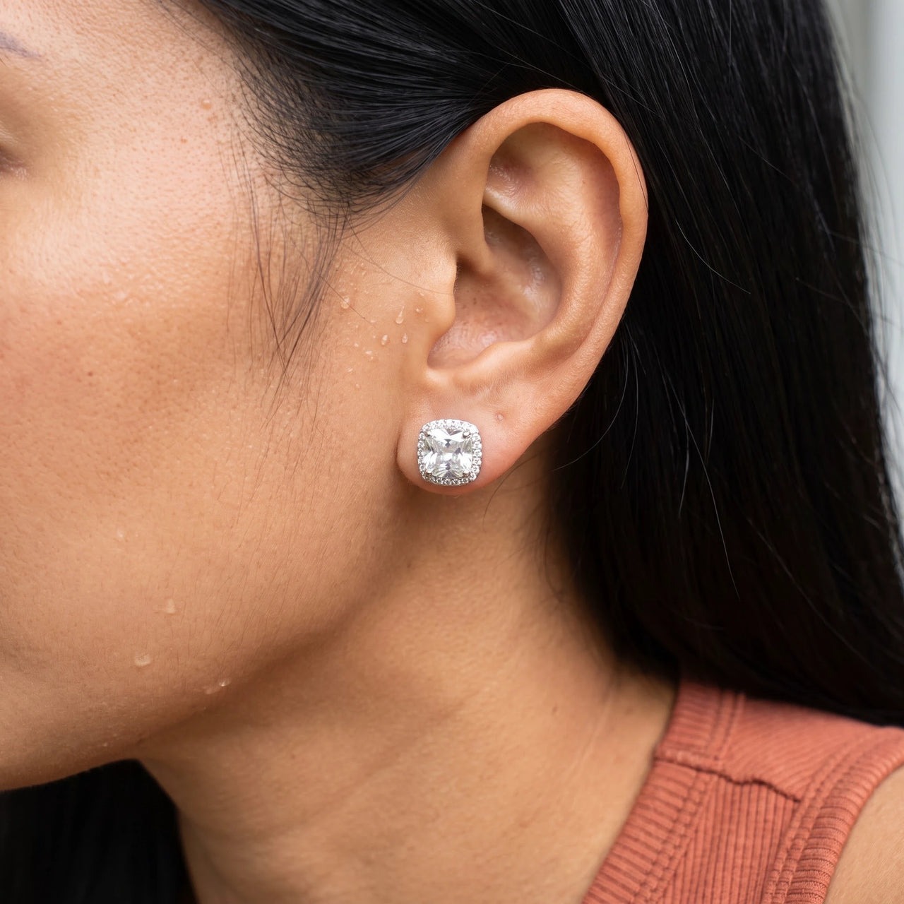 Close-up of the silver stud earrings worn on the skin | SKU: 505185-white